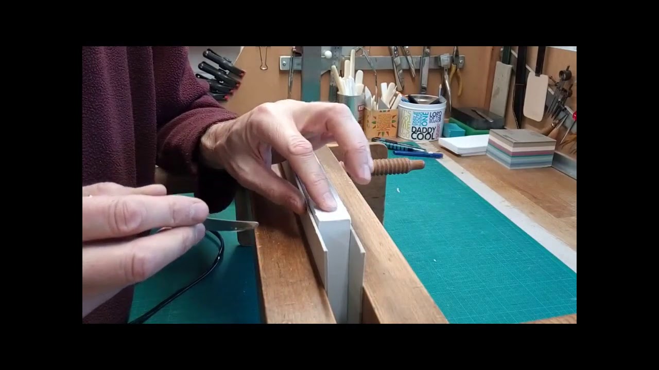 Bookbinding:  Cleaning plastic-glued book spines