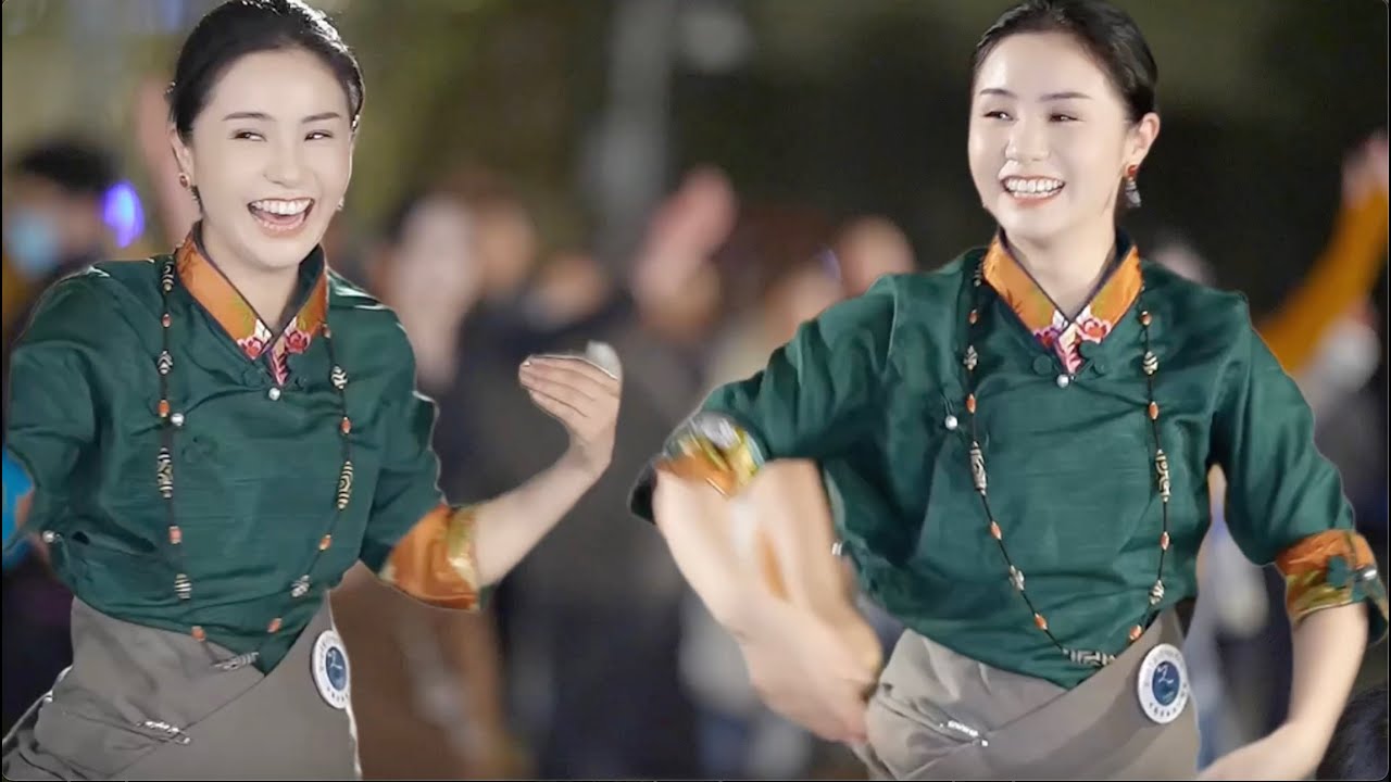 Восхищаться красивыми тибетскими танцорами, традиционными тибетскими танцами и тибетской песней