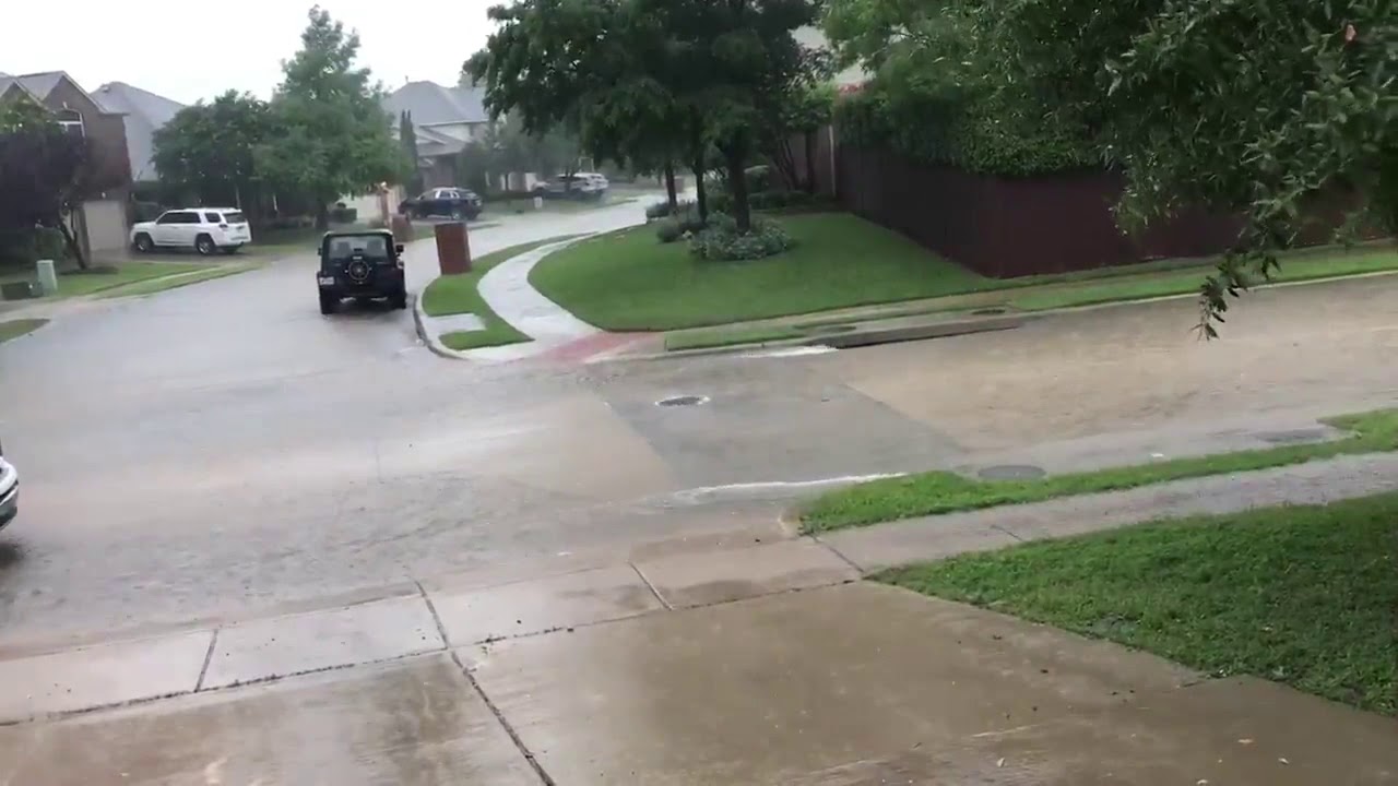 Heavy rain causes storm drain manhole cover to bounce