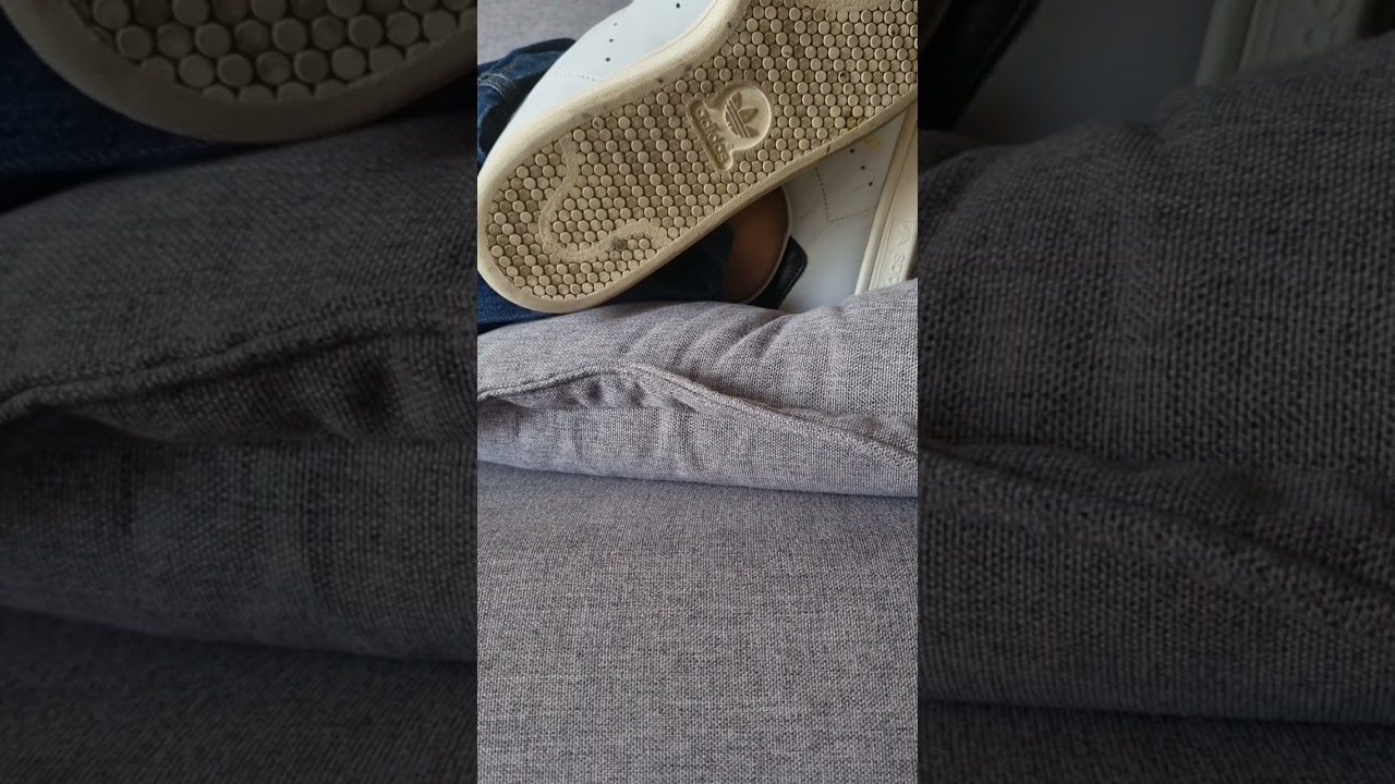 Dirty adidas stan smith with no socks relaxing on the couch. 