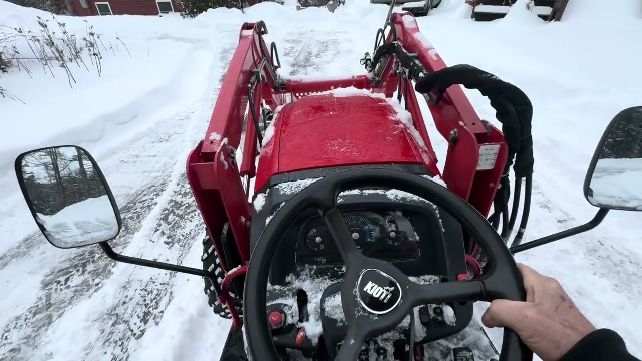 Back dragging snow with a tractor 