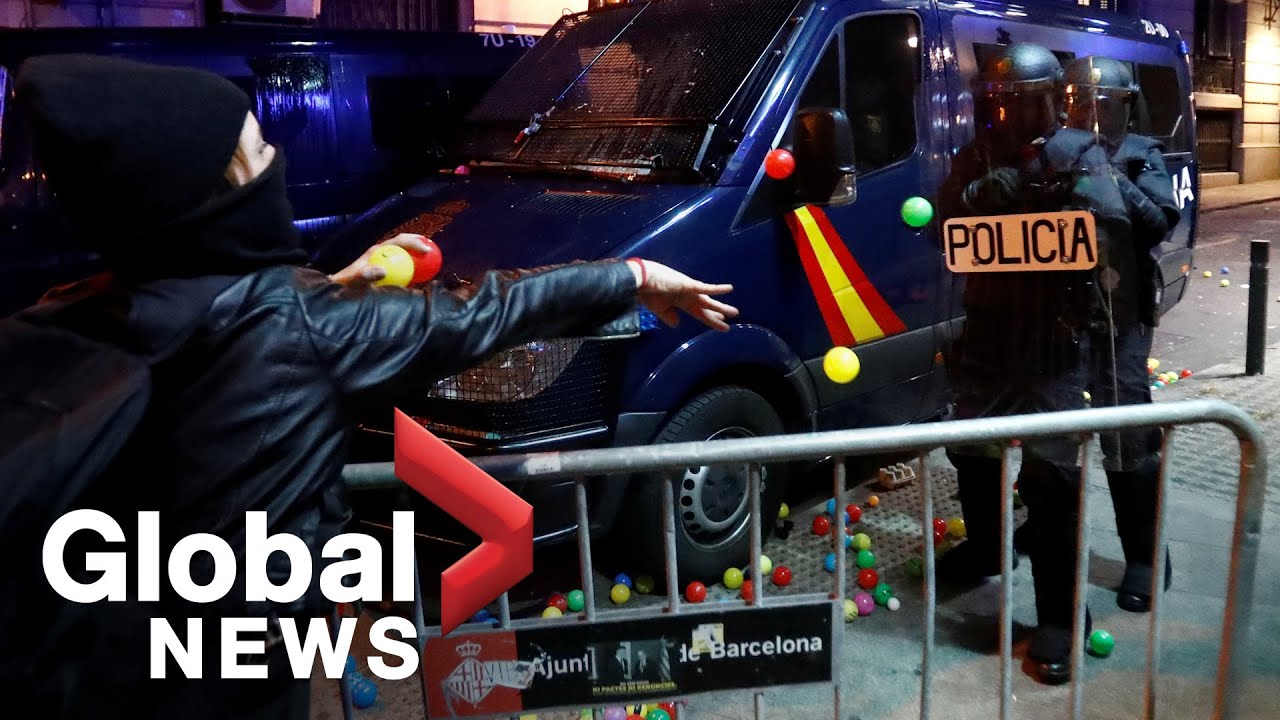 Catalan protesters vandalize police cars, hurl paintballs at police during rally outside Spanish HQ