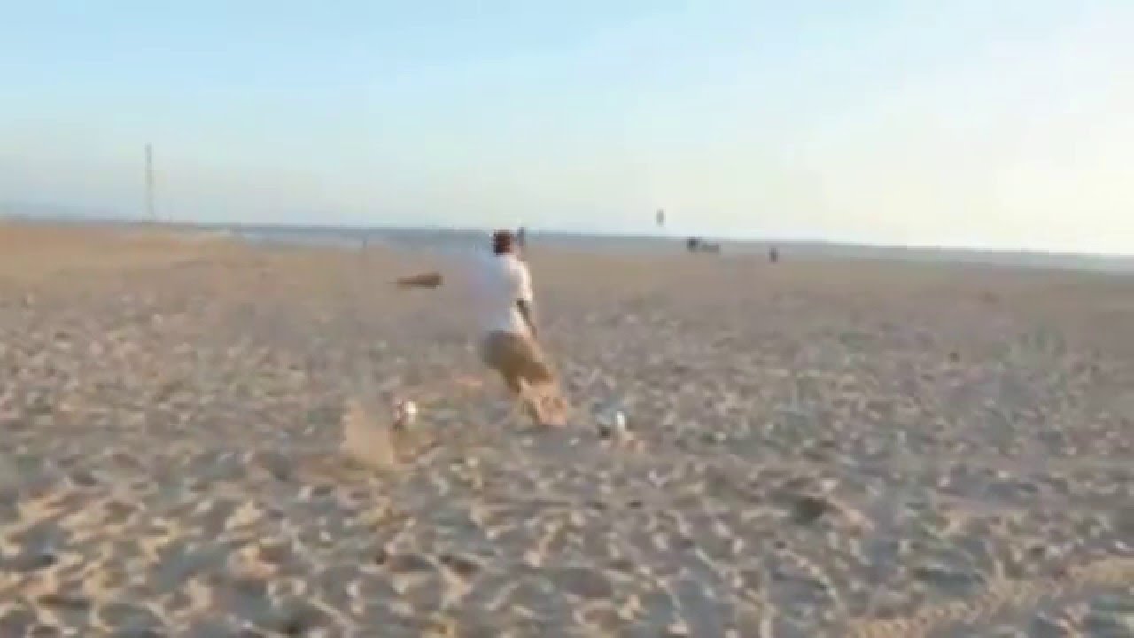 Soccer Player David Beckham kicking balls into distant bins