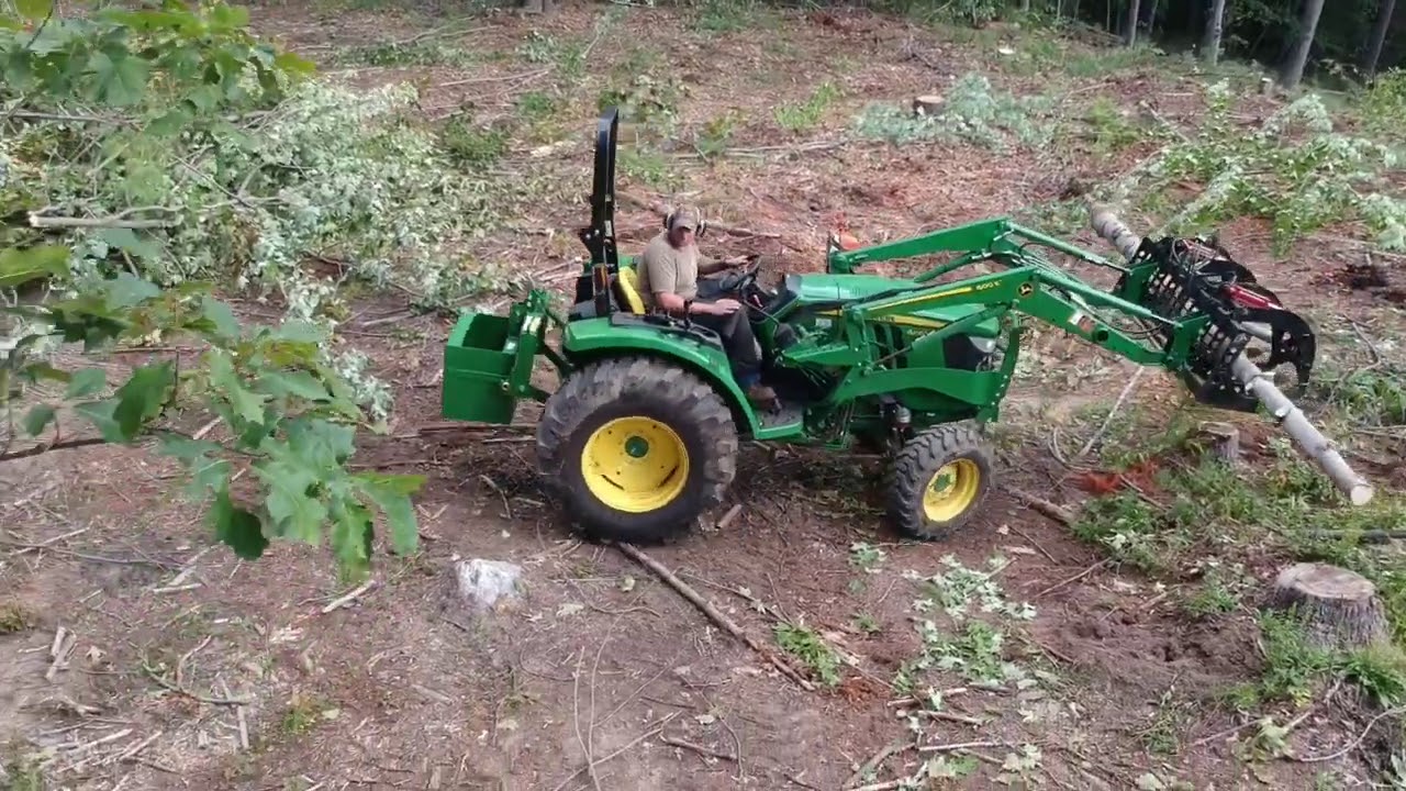 John Deere 4052m with EA wicked root grapple.