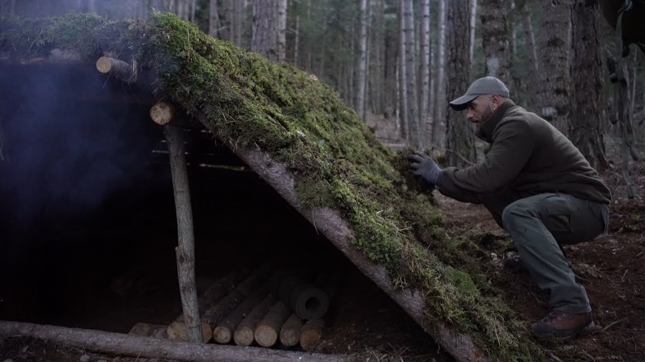 Big earth shelter built and covered with moss, bed, fire inside, birds singing in spring (ASMR)