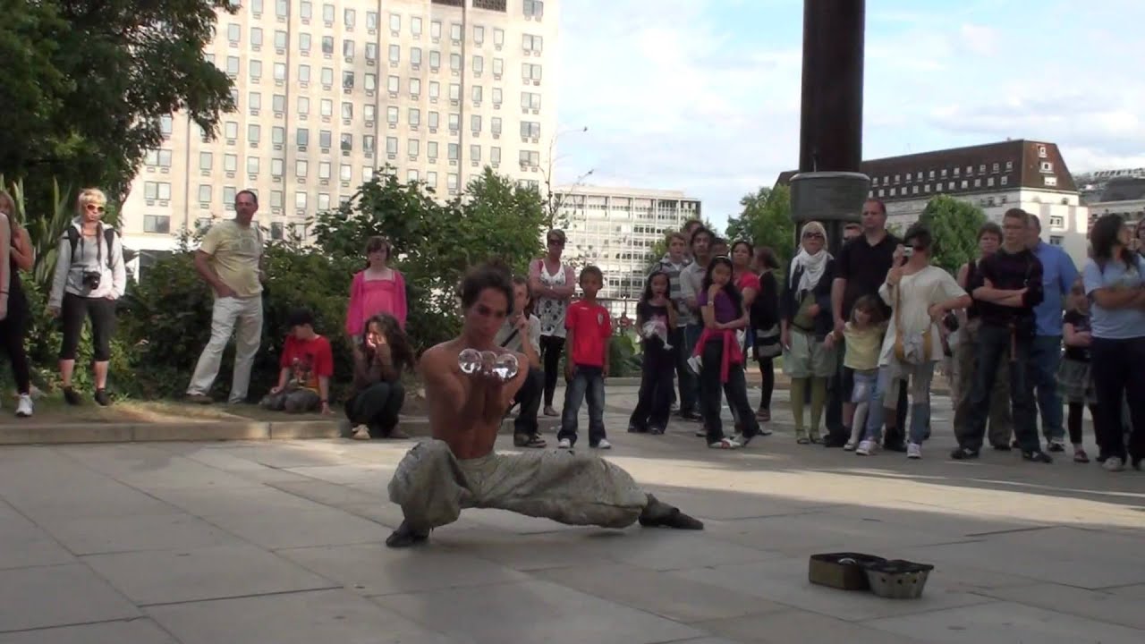Contact juggling street performance in London