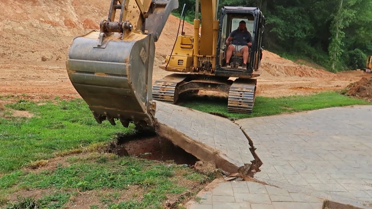 Excavator Removing Concrete Slab