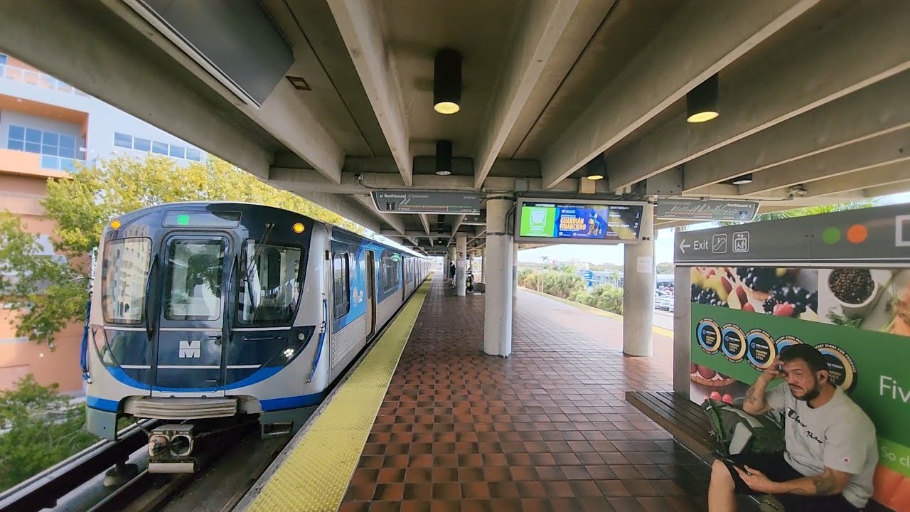 Miami Metrorail Southbound Green Line train arriving and departing at Dadeland North Station. 