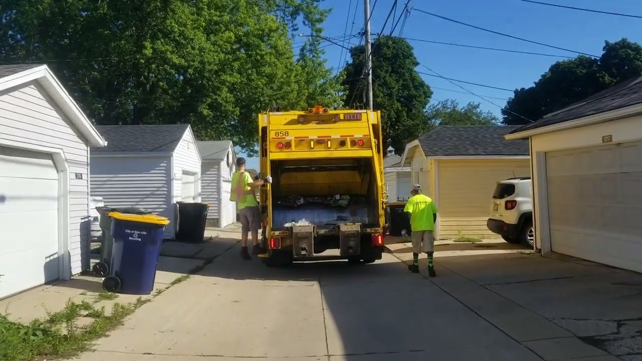 West Allis yellow Peterbilt Heil rear loader garbage truck on recycling