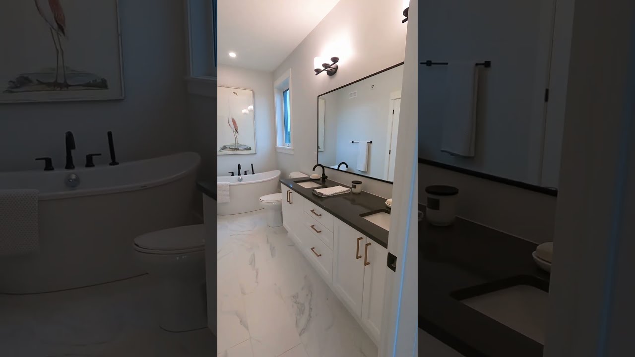 Unwind in the Benson's primary en suite, featuring a spa-like soaker tub, double sinks, and shower.