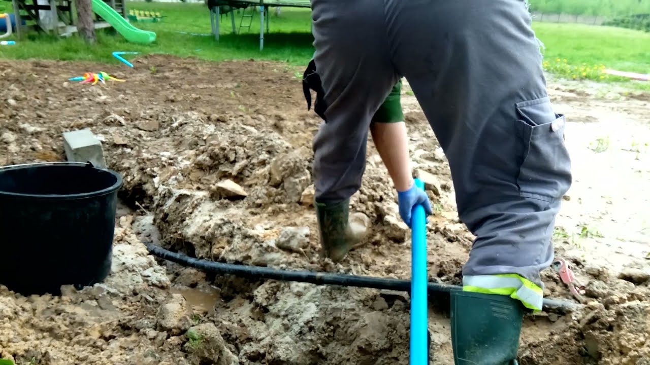 Wpuszczanie rury fi 40 milimetr&oacute;w do budynku przy użyciu młotka
