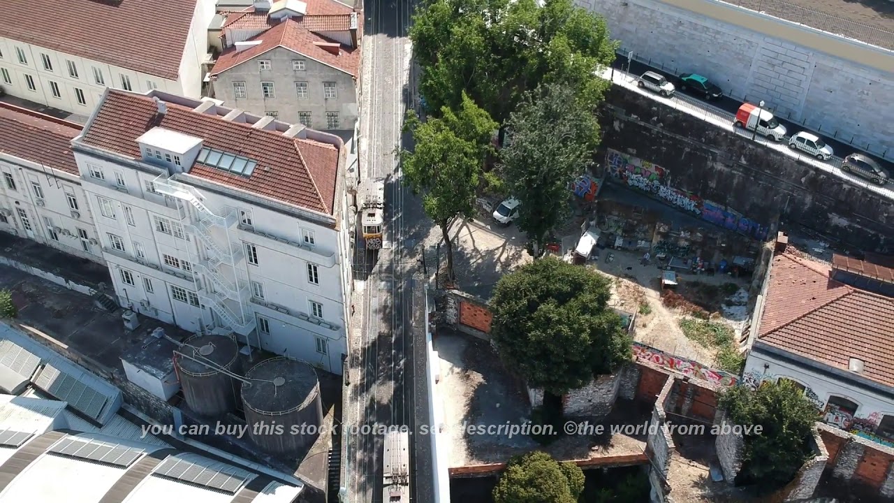 Aerial Stock Footage: Flying over Tram 28 in Lisbon, Portugal with Drone. Aerial view of Lisbon