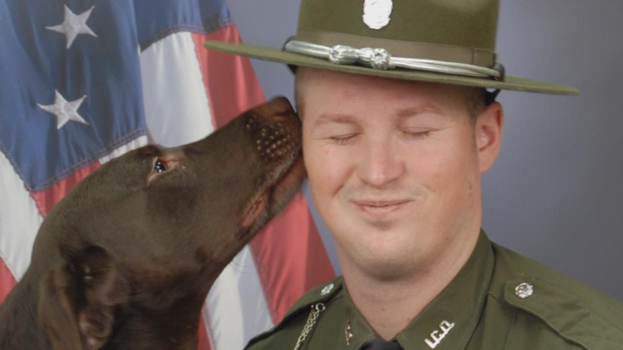 K9 Officer Licks Partner In Their Official Department Photo