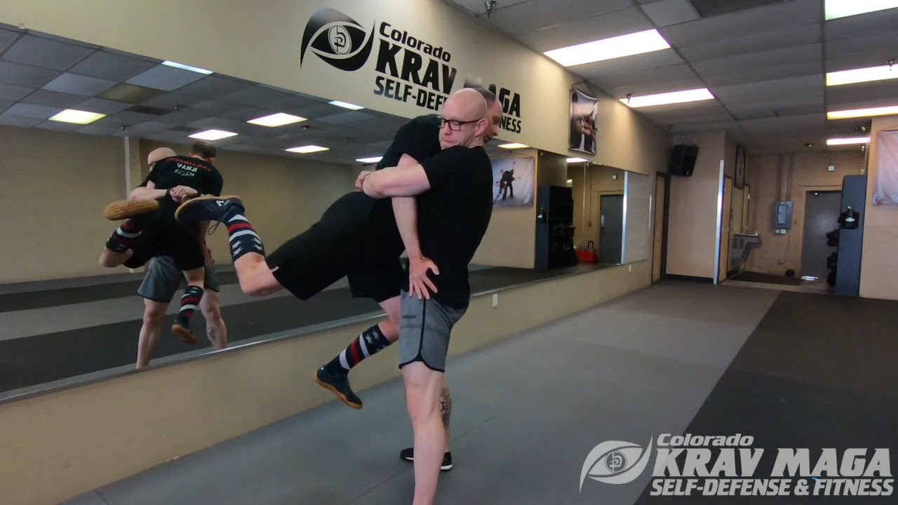 Defending a bear hug from front being lifted