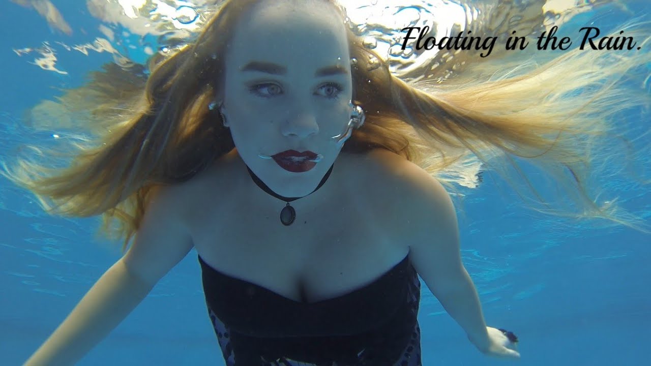 Gothic mermaid floats under the surface in the rain!🖤☔#GoPro #underwatergirl #underwaterphotography