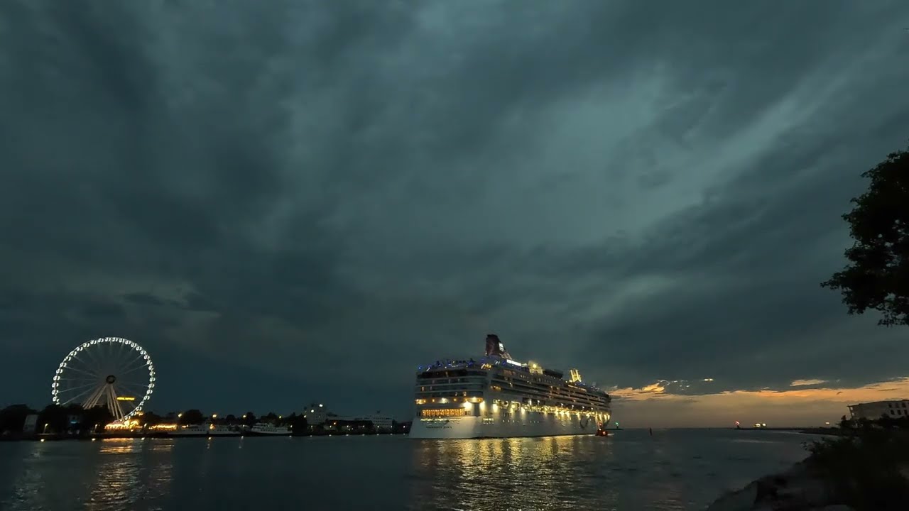 Warnemünde, a sunset cruise in the port of Warnemünde at night. Cruise ship in the Baltic Sea