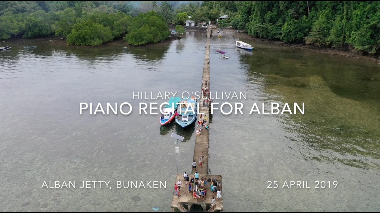 Piano over the Sea. Hillary's Piano Recital at the jetty of an Indonesian island, Bunaken.