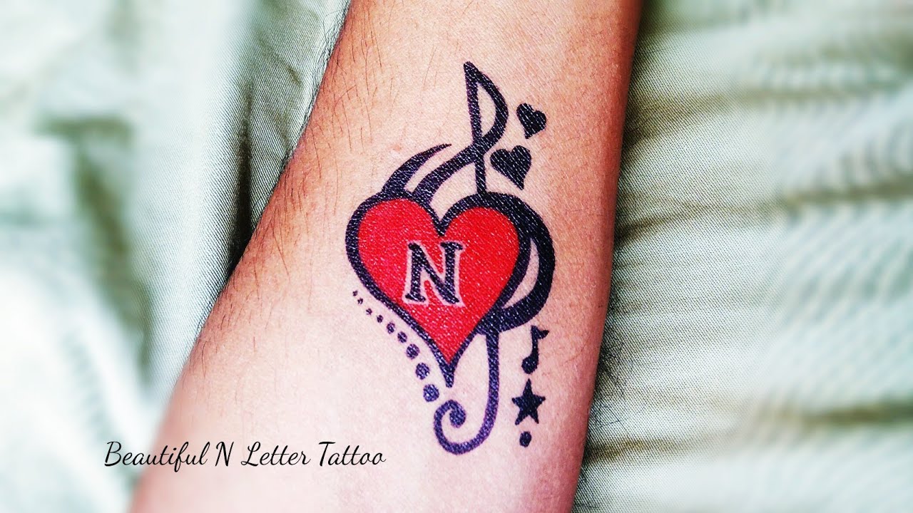 N Letter Tattoo with heart and music simble