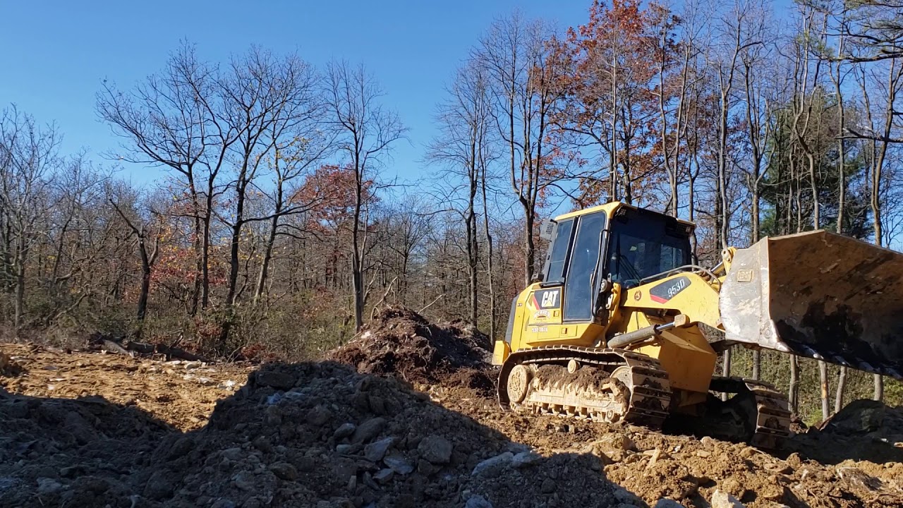 953d cat track loader grading rocks