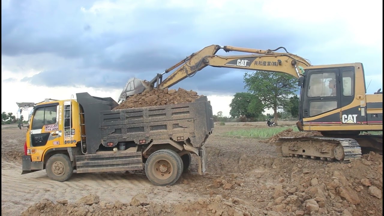 Excavator Loading Land On Truck - Caterpillar 312B