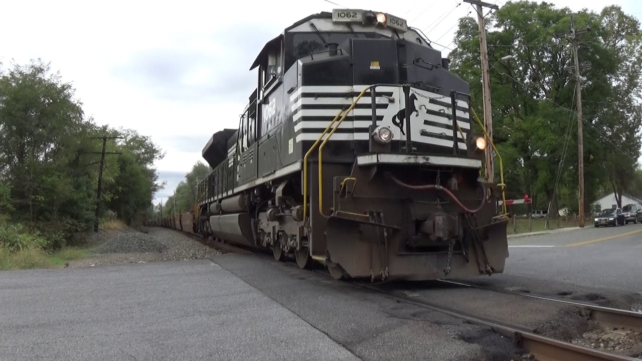 A solo SD70ACE pulls baretable train I4Q past Josephine Street