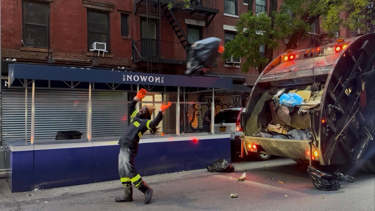 NYC rear load crew having fun tossing morning trash