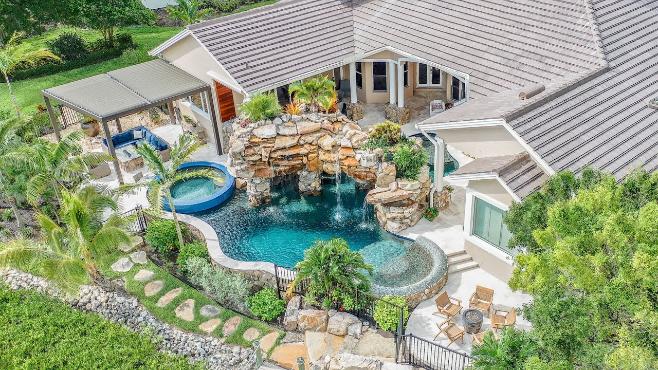 Tropical Backyard Paradise in Fort Myers with Insane 300-square-foot natural rock grotto waterfall!