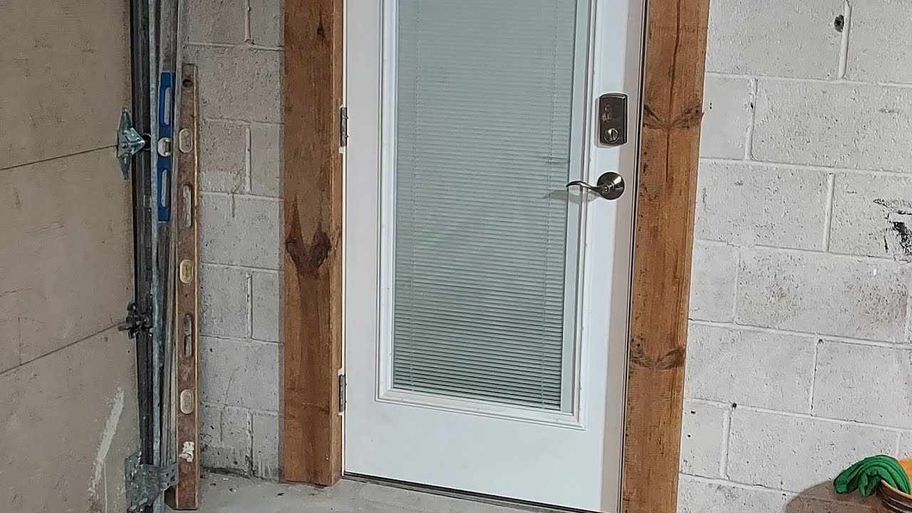 How to install exterior door on cinder block building with cement floor