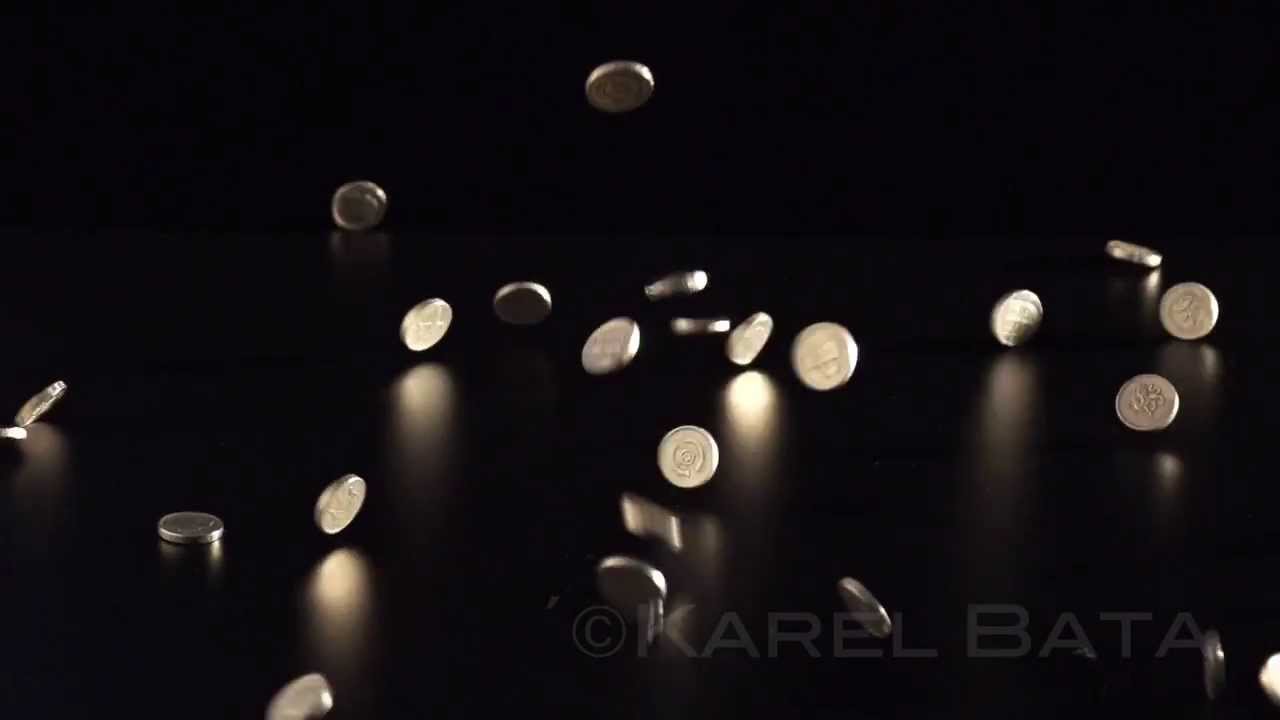 Slow Motion &pound;1 Coins Falling On To Table