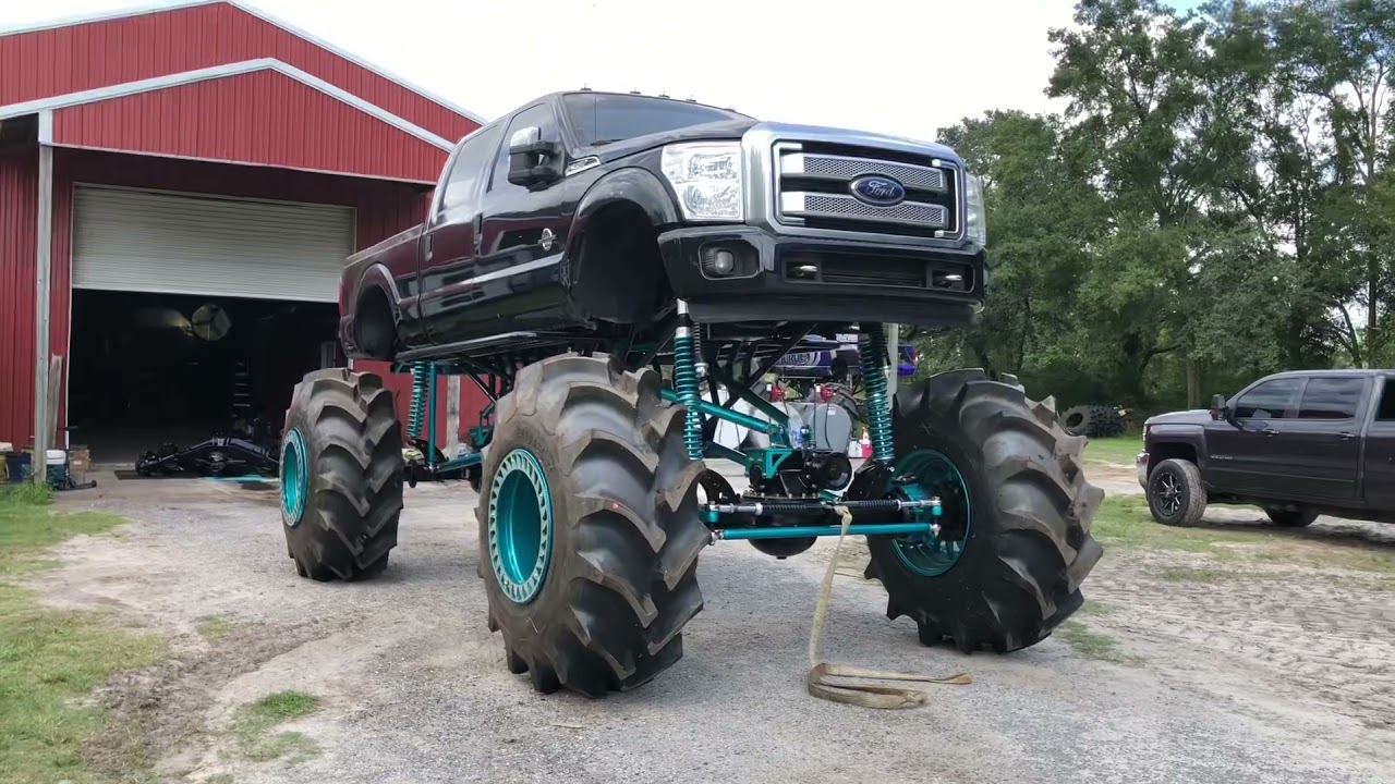 Painting the bottoms of 2 mega trucks mud trucks. 5 tons and Axletech 4000s finished for Ironhorse