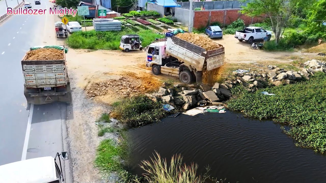 Full Processing Filling Up The Land, Bulldozer KOMATSU D31P, Dump Truck Unloading