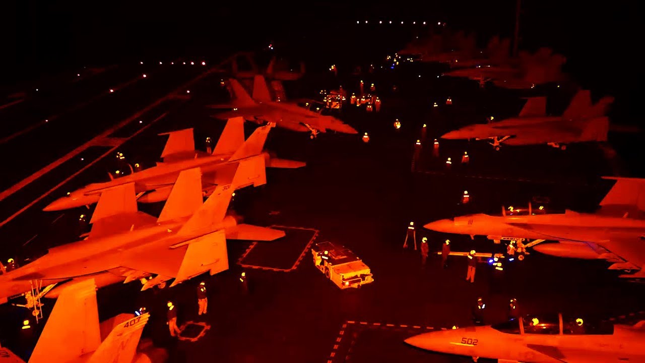 Intense And Dangerous Nighttime Flight Operations On Aircraft Carrier's Flight Deck