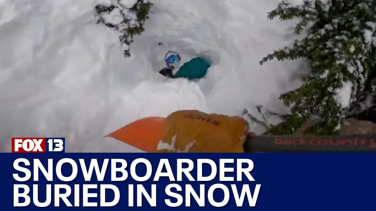 Dramatic video shows rescue of snowboarder buried in snow by a skiier who was in the right place at