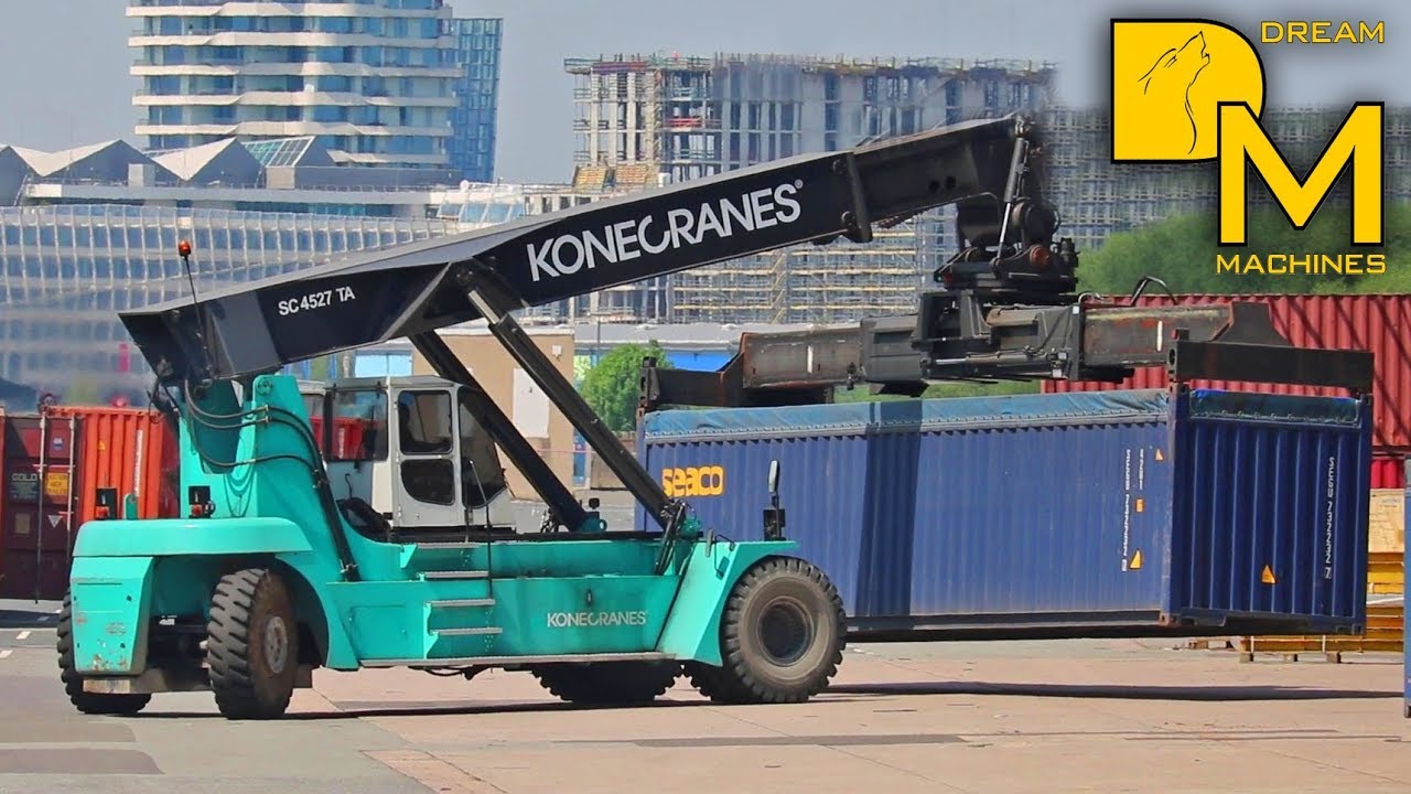 MASSIVE REACH STACKER GIANT FORKLIFT MOVING HEAVY CARGO IN THE HARBOR