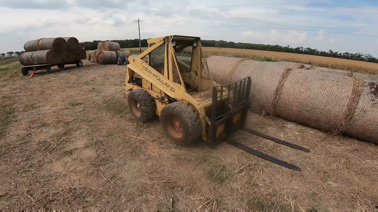 New Holland L775 Skid Steer Stacking Round Bales