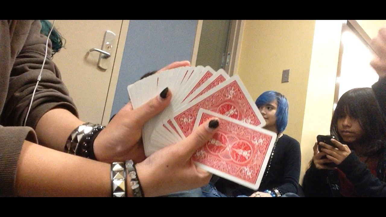 a bunch of teens playing cards