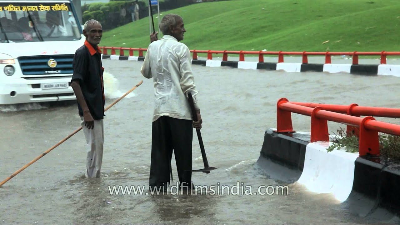 Old men try and control the traffic at Aiims flyover - Delhi Monsoons