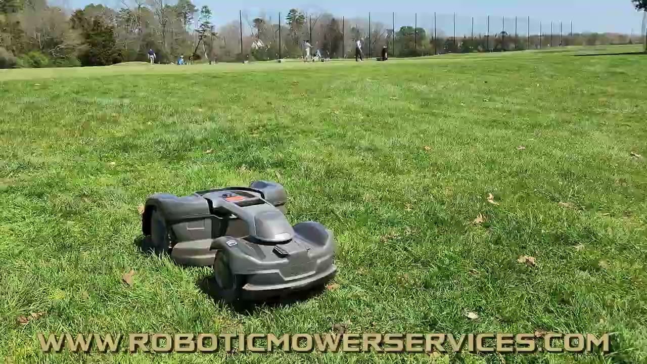 Husqvarna 435X Automower Mowing Around A Driving Range At A Golf Course.