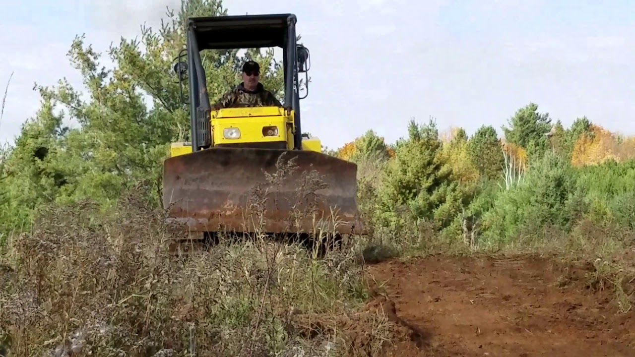 Yea, it pushes dirt.  Small Dozer