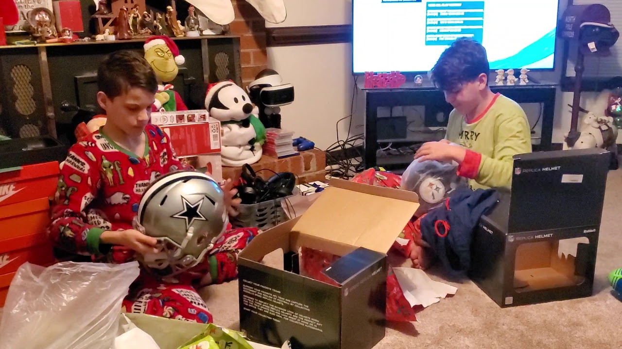 The boys get autographed Dallas Cowboys and Pittsburgh Steelers helmets