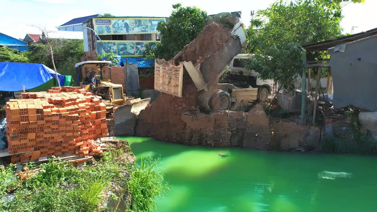 Landfill Project: Dump Truck Dumping Soil a Deep pond Hidden Pollution | Bulldozer Pushing a Site
