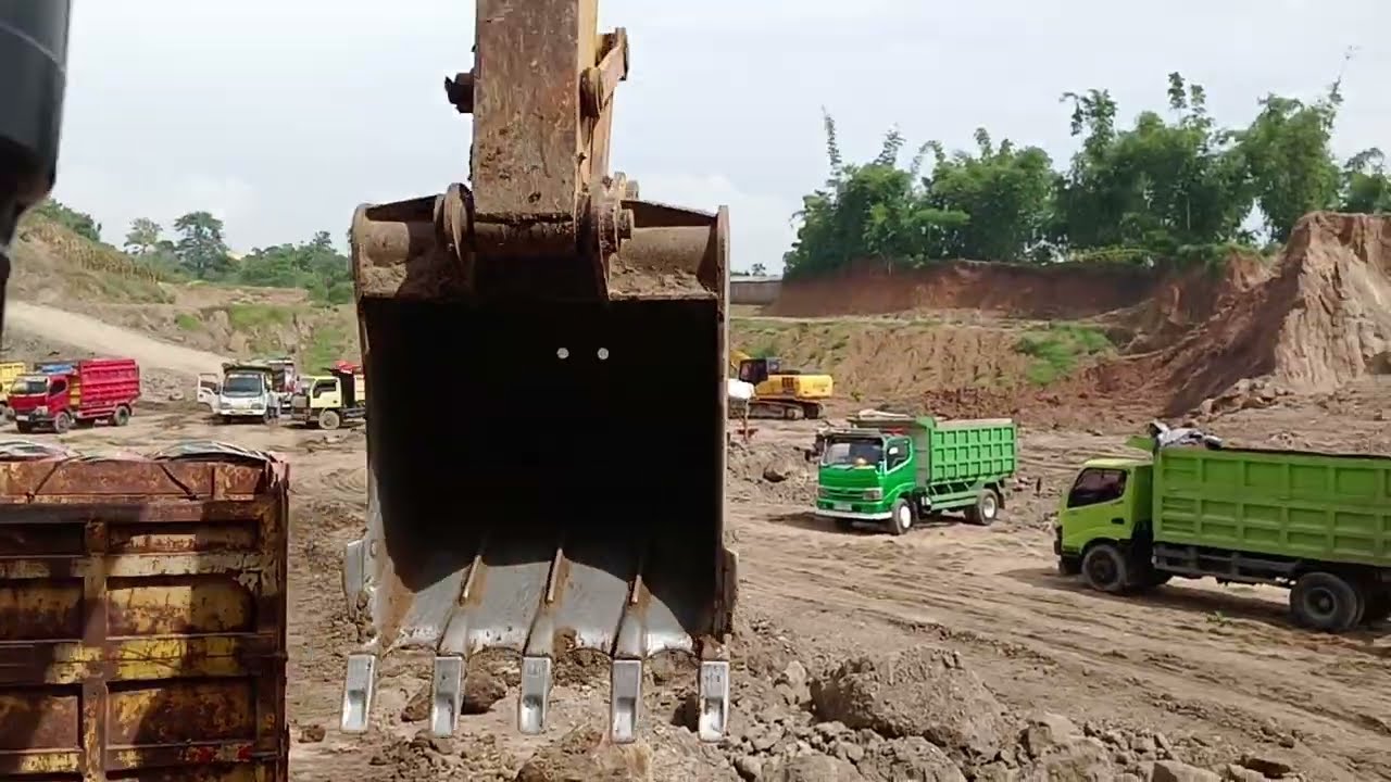 Massive Mining Excavator, the Caterpillar 320Gx Loading a Truks