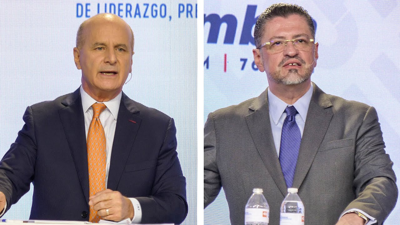Rodrigo Chaves y José María Figueres en la sección 