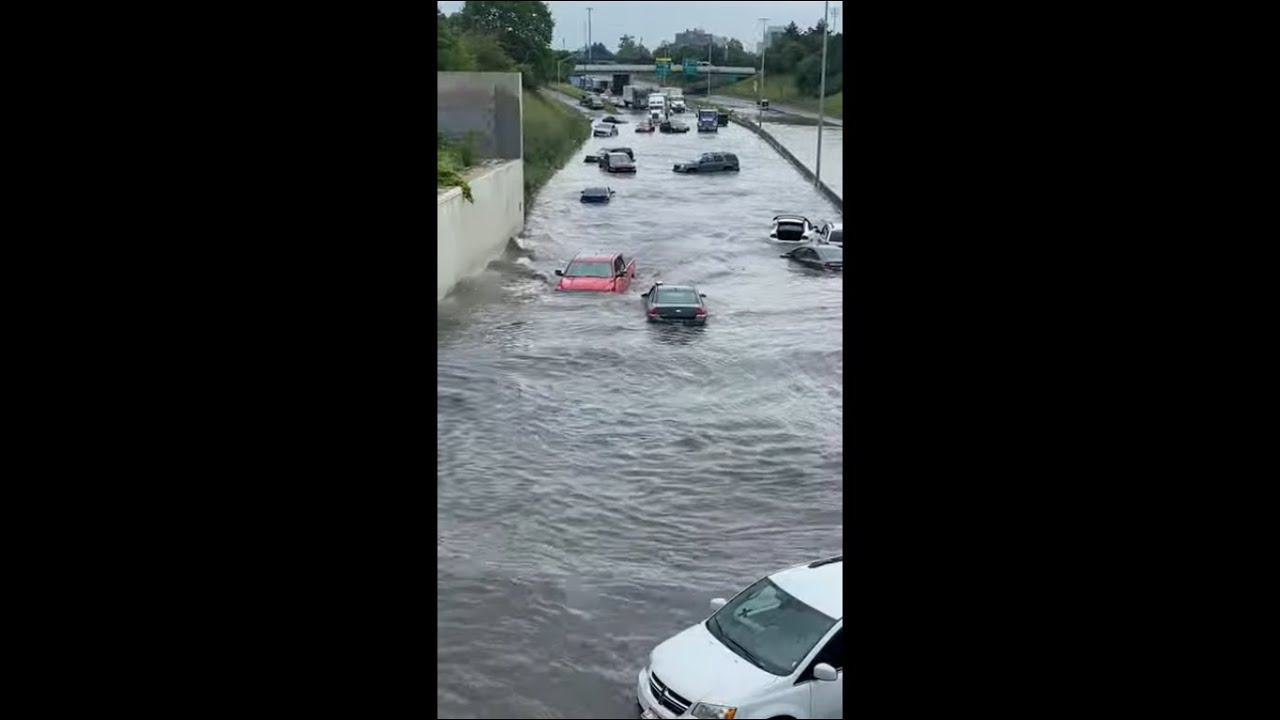 Truck Driving While Submerged in Water That Flood the Road