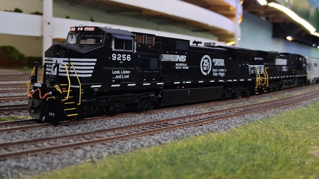 New Scaletrains Operation Lifesaver NS 9256 and Thoroughbred NS 9700 lead a manifest train!