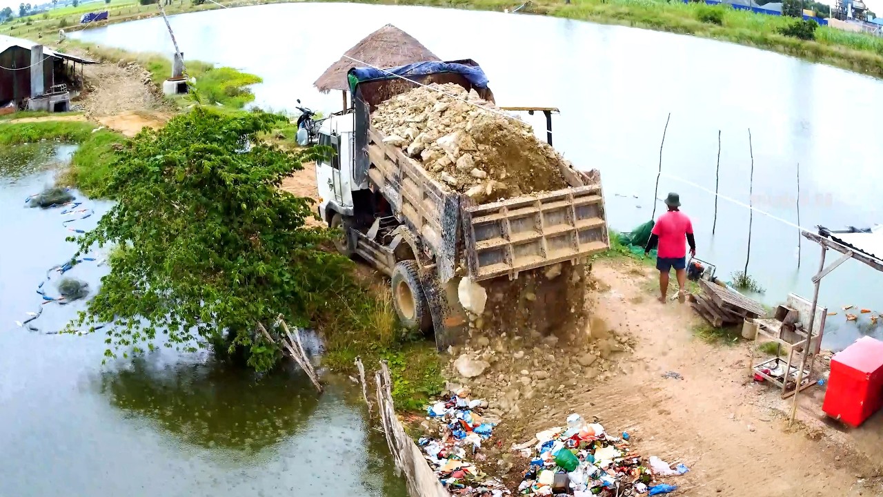 Amazing job and excellent driver use BULLDOZER push stone for fixing the road around the lake