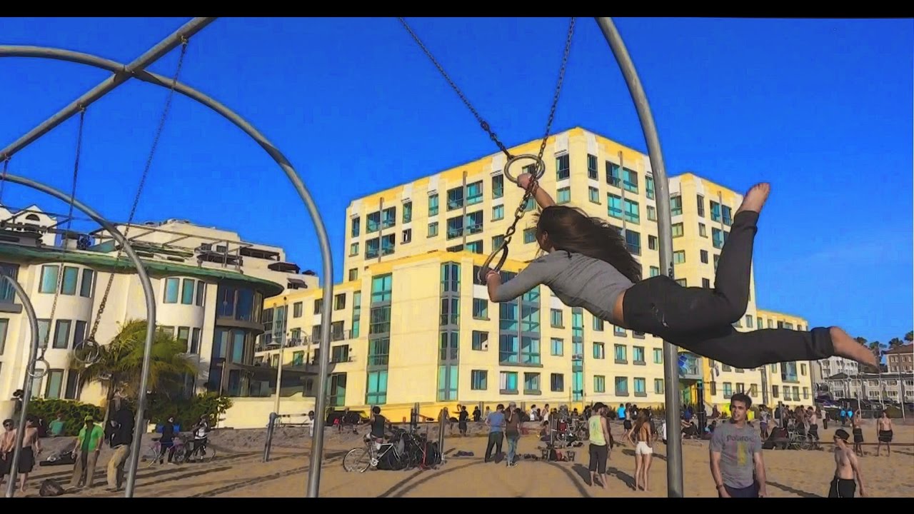 Cute acrobat flies on Traveling Rings, Santa Monica Pier, ORIGINAL MUSCLE BEACH