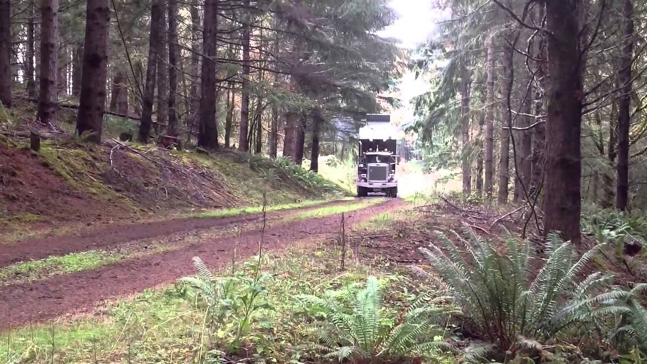 Spreading load of rock with Peterbilt dump truck