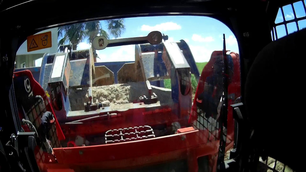 loading a dumpster with a demo dozer bucket