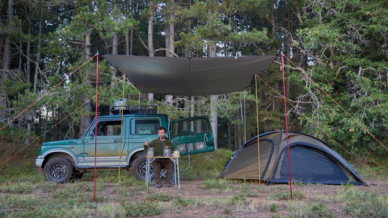 Car camping overlanding in the middle of the forest, relaxing with a nice landscape...